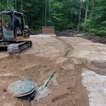 Septic system installation with excavator in Grey County Ontario
